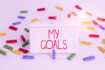 Writing note showing My Goals. Business concept for a future or desired result that a demonstrating commits to achieve Colored clothespin papers empty reminder white floor background office