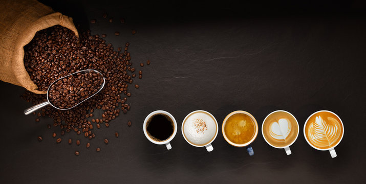 Variety of cups of coffee and coffee beans in burlap sack on black background.