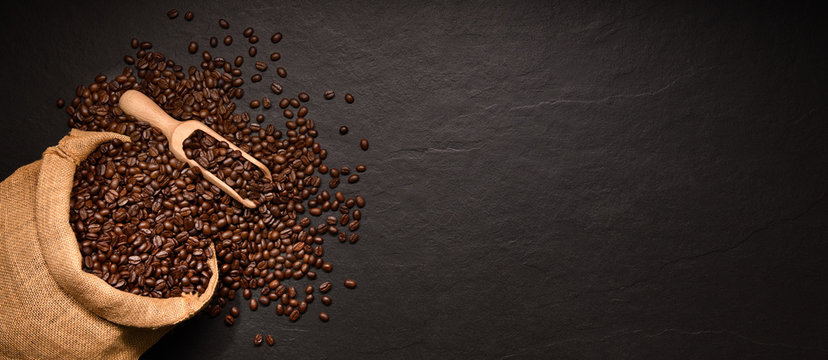  Coffee beans in burlap sack on black background