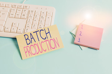 Text sign showing Batch Production. Business photo text products are analysisufactured in groups called batches Paper blue desk computer keyboard office study notebook chart numbers memo
