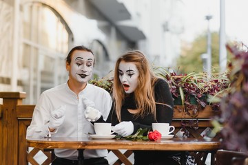 A couple of merry mimes. He hurries on a date.