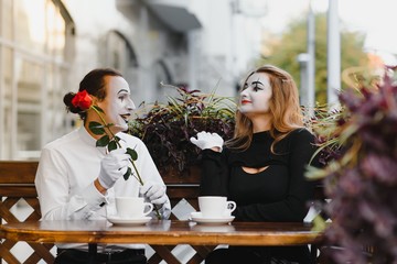 Male mime giving a flower to female mime