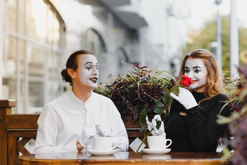 Male mime giving a flower to female mime