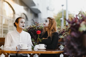Male mime giving a flower to female mime