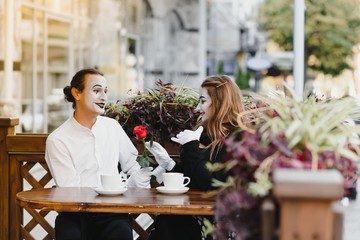 Male mime giving a flower to female mime