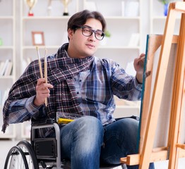 Disabled artist painting picture in studio