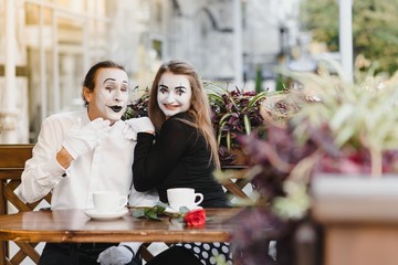 A couple of merry mimes. He hurries on a date.