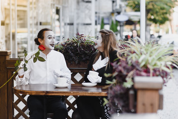 Male mime giving a flower to female mime