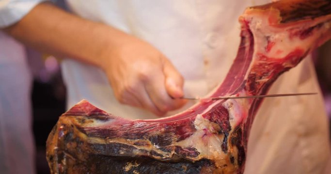 slicing Jamon, Pata Negra in a market, Mercado, Spanish Ham