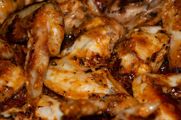 Chicken wings marinated with spices fried in a pan. Home cooking