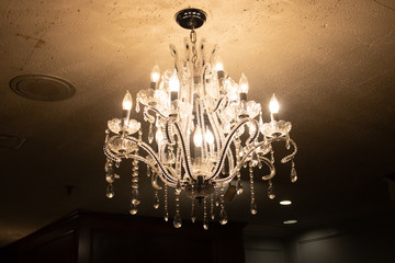 chandelier in a room in a building that is very dark 