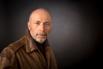 Obraz premium headshot of older man in leather jacket