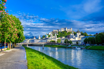 A view of the Austrian city of Salzburg along the Salzach River. - obrazy, fototapety, plakaty