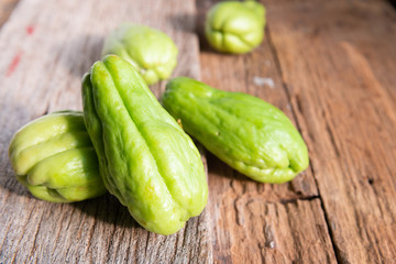 Fresh chayote fruits (Sechium edulis) on wood background