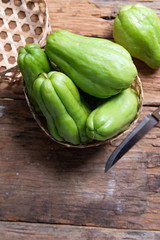 Fresh chayote fruits (Sechium edulis) on wood background