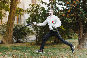 Portrait of a man, artist,clown, MIME. Shows something. Mime actor shows different emotions.