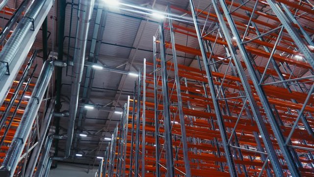 rows of racks with red planks in storehouse low angle shot