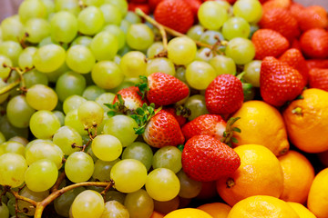 Fresh ripe fruits, grapes, strawberry, tangerines. Close up.