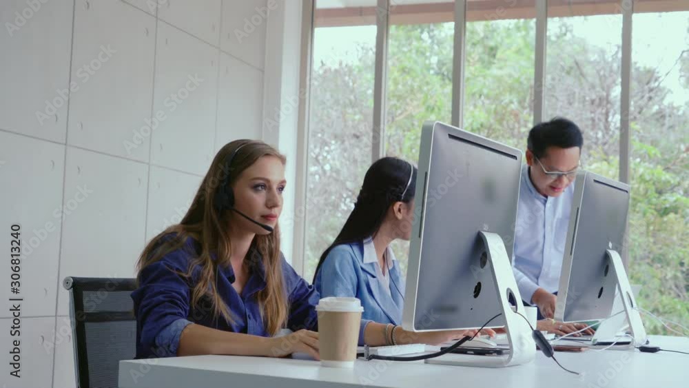 Aufkleber customer support agent or call center with headset works on desktop computer while supporting the cu