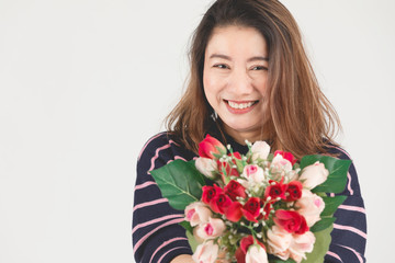 Asian smiling  woman on gray studio shot with red rose flower.