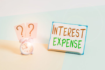 Conceptual hand writing showing Interest Expense. Concept meaning cost of debt that has occurred...