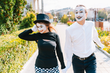 A couple of merry mimes. He hurries on a date.