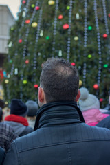 man sitting on a bench in winter park boston christmas 
