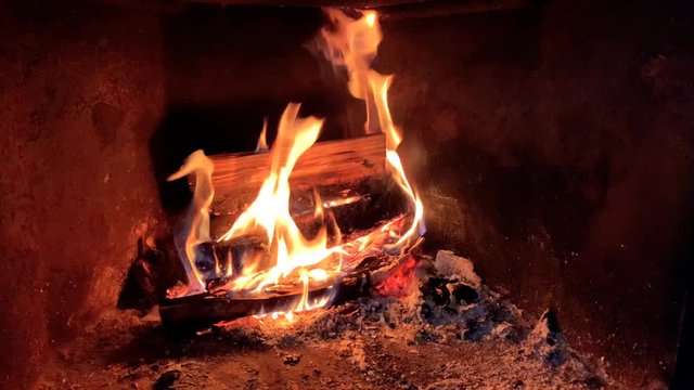 Burning logs in fireplace with open flames