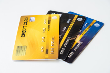 Close up of a set of cradit cards isolated on white background. Credit card lets cardholders borrow funds with which to pay for goods and services depend on the condition that cardholders pay back.