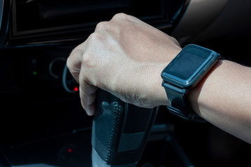 Obraz premium Hand of man holding automatic transmission lever while driving.