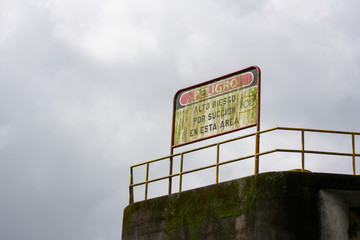 faded sign with green moss