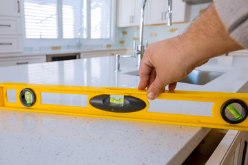 Workers installing top counter kitchen interior cabinet