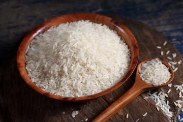 Fototapeta na wymiar Close up white rice in measuring cup on table, Thai Jasmine rice in rustic kitchen background