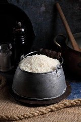 Close up white rice in measuring cup on table, Thai Jasmine rice in rustic kitchen background