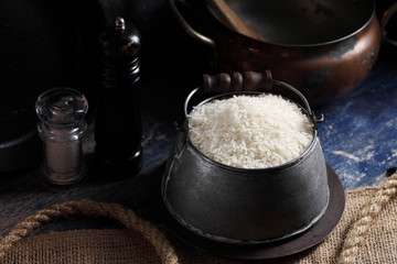 Close up white rice in measuring cup on table, Thai Jasmine rice in rustic kitchen background