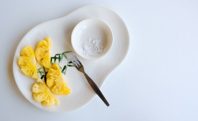 Pineapple sliced in white backdrop with copy space