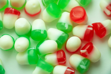 Isolated Red and Green Jelly Candy Close Up Colorful candy used for decorating Christmas trees and gingerbread houses. Holiday treat. Macro view. White background. Fun and sweet