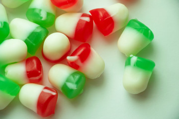 Isolated Red and Green Jelly Candy Close Up Colorful candy used for decorating Christmas trees and gingerbread houses. Holiday treat. Macro view. White background. Fun and sweet
