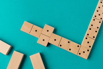 Playing dominoes on a blue background. Leisure games concept. Domino effect.
