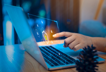 Businessman using a laptop computer with technology cybersecurity and privacy concept. protection and safe data for global network security.