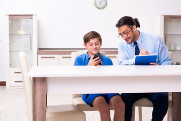 Busy father helping his son to prepare for exam