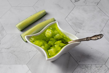 Cucumber jam in a bowl, on a light background