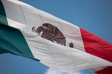 Obraz premium Mexico flag outdoors with blue sky