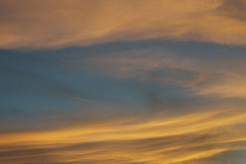 Fototapeta na wymiar Blue sky hole that surrounding by glowing orange cloud in an evening