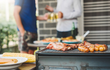 Afternoon Party Group friends enjoying drinking beer with barbecue and roast pork happy while...