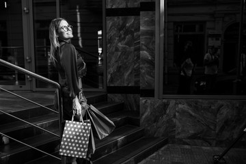 Fototapeta na wymiar Woman in shopping. Happy woman with shopping bags enjoying in shopping. Consumerism, shopping, lifestyle concept