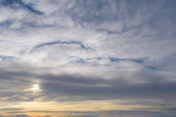  setting sun behind wispy clouds