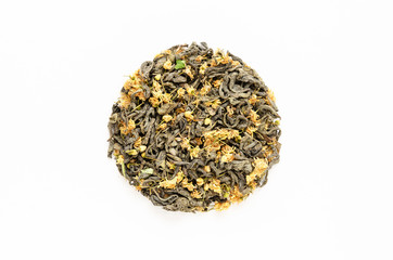 Dried green tea leaves with linden flowers on white background. Healthy natural drinks concept. Close-up. Top view