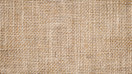 Cotton woven fabric background with flecks of varying colors of beige and brown. with copy space....