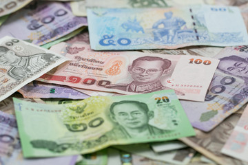 Obraz na płótnie Canvas Thai money - Baht.Thai money - Baht.Pile of various currencies isolated on white background.Thai baht banknote coin isolated on white background.Many of Thai Baht background.Thai currency.